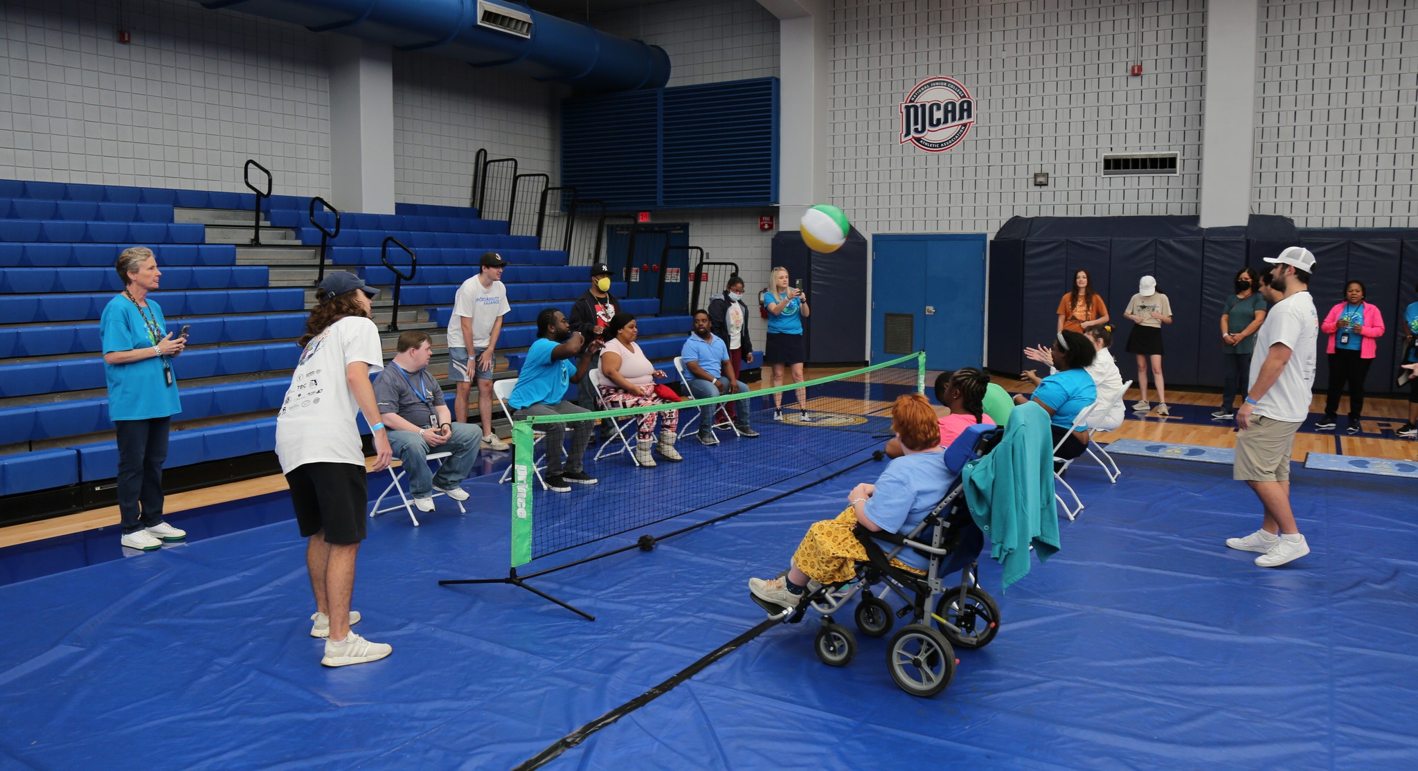 people of all abilities playing sit volleyball in a gym
